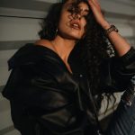 A woman sitting on the ground with her hand on her head