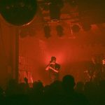 a person on a stage with a microphone in front of a crowd