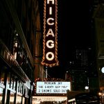 Chicago theater sign at night with crowd