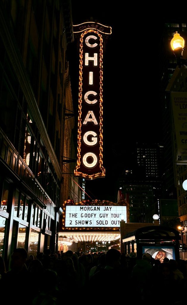 Chicago theater sign at night with crowd