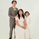 A mother with her two children posing for a portrait.