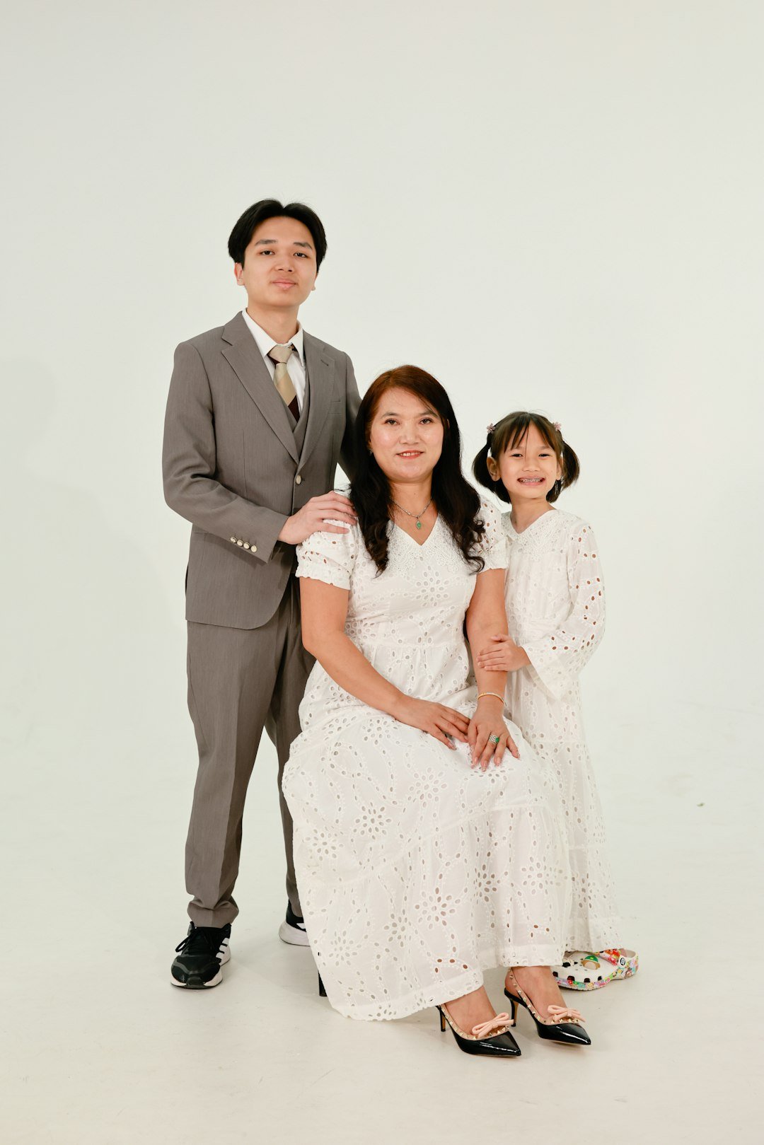 A mother with her two children posing for a portrait.